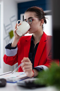 Young woman drinking coffee in cafe