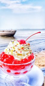 Close-up of dessert with ice cream against sky