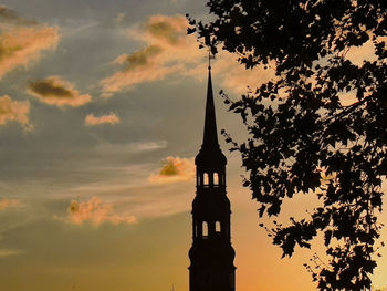 Low angle view of silhouette building against sky during sunset