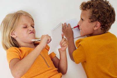 Sibling drawing on paper on white background