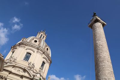 Low angle view of bell tower against blue sky