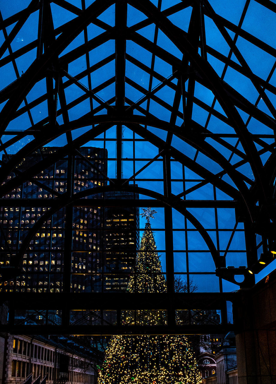 LOW ANGLE VIEW OF GLASS CEILING IN BUILDING