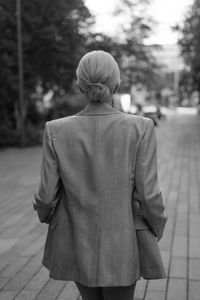 Rear view of woman walking on street