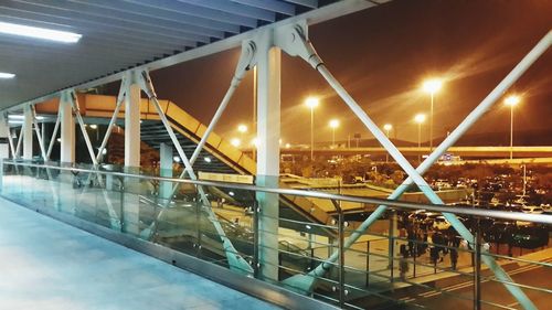 Illuminated metal bridge at night