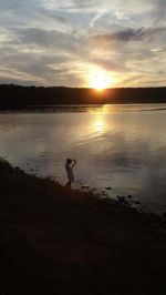 Scenic view of lake at sunset