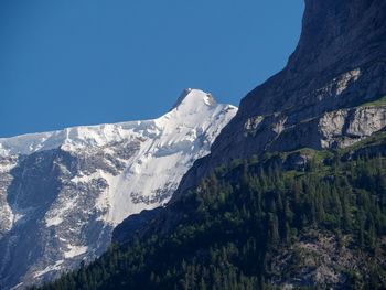 Scenic view of snowcapped mountains against clear blue sky