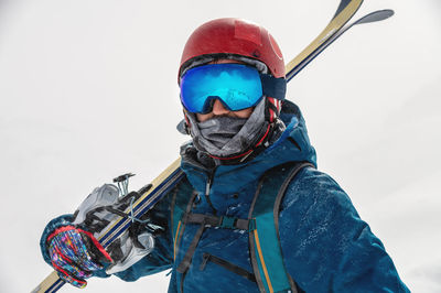 Young man on a ski vacation in the mountains, portrait. great rider holiday in ski resort