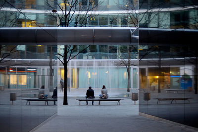 Rear view of people walking in modern building