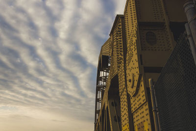 Low angle view of building against cloudy sky