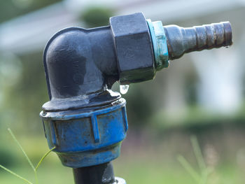 Close-up of water pipe on field