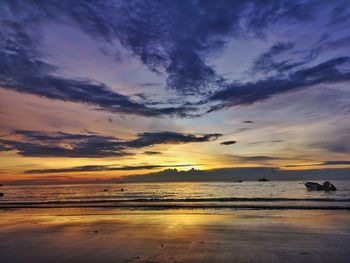 Scenic view of beach against sky during sunset