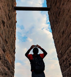 Rear view of man standing against sky