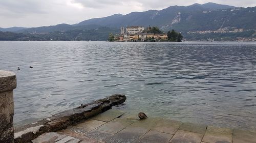 Scenic view of lake and mountains against sky