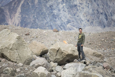 Hiker burns toilet paper after using washroom in a remote location.