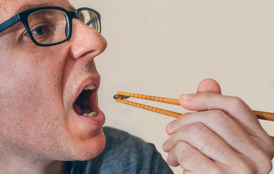 Man eating worms in restaurant