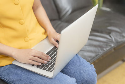 Midsection of woman using mobile phone