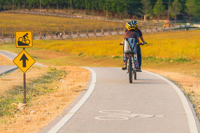 People riding bicycles on road