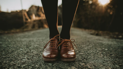 Low section of person standing on street