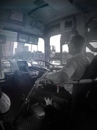 Rear view of man sitting in bus