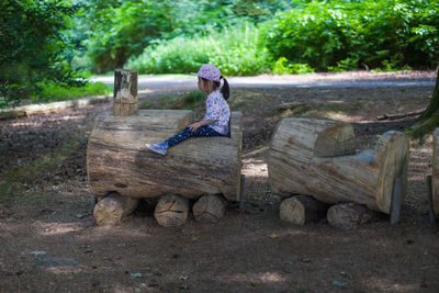Full length of woman sitting on bench