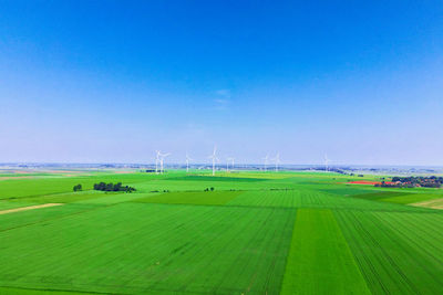 Windmill turbines in green field, wind energy concept