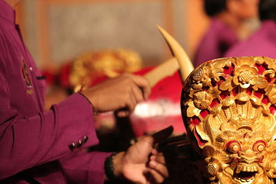 Midsection of man playing gamelan