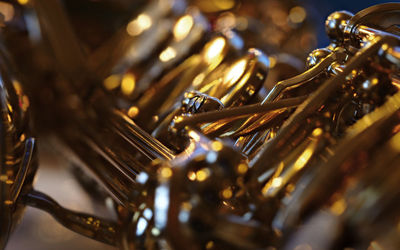 Close-up of a saxophone in front of a christmas tree.