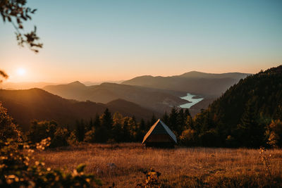 Scenic view of field against sky during sunset