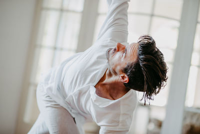 Young man dancing on hardwood floor