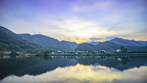 Scenic view of lake and mountains against sky