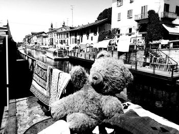 View of boats in canal by buildings