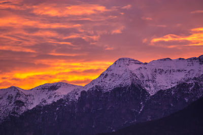 Scenic view of snowcapped mountains during sunset