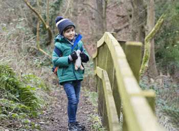 Full length of a boy standing in forest