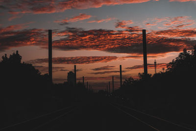 Railroad tracks against sky during sunset
