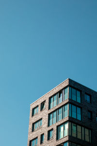 Low angle view of building against clear blue sky