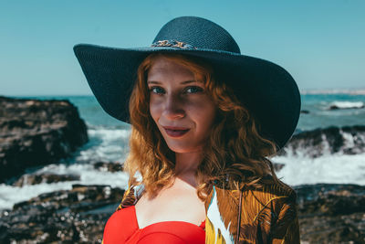 Portrait of smiling woman standing on beach