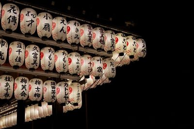 Low angle view of temple hanging against black background