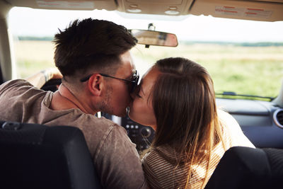 Portrait of friends sitting in car