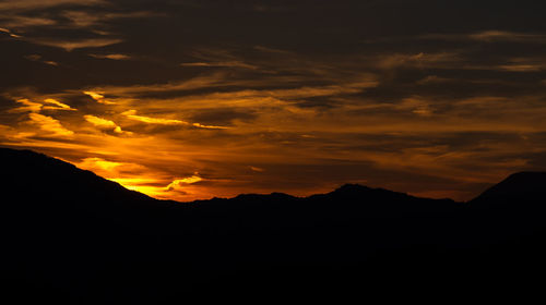 Scenic view of silhouette mountains against sky during sunset