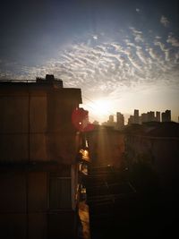 Silhouette buildings against sky during sunset