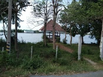 House on field against trees and houses