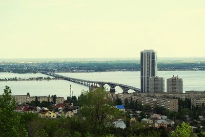 High angle view of buildings by river against sky