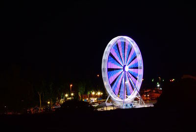 Illuminated ferris wheel at night