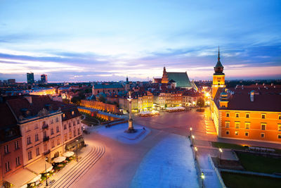 High angle view of city lit up at dusk