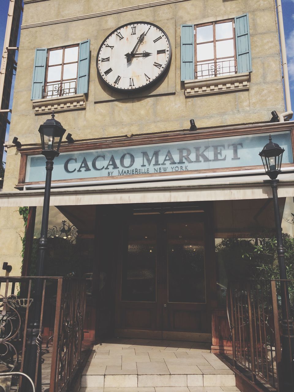 architecture, built structure, clock, building exterior, low angle view, text, time, communication, window, western script, entrance, day, door, outdoors, number, old, no people, old-fashioned, clock tower, building