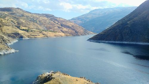 Scenic view of lake and mountains against sky