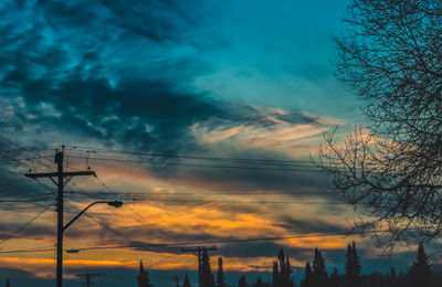 Low angle view of silhouette trees against sky during sunset