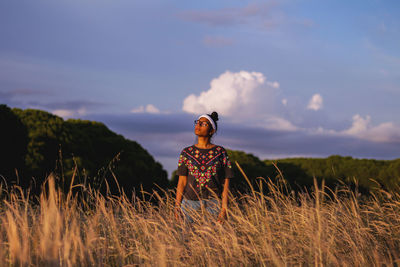 Women standing on field against sky