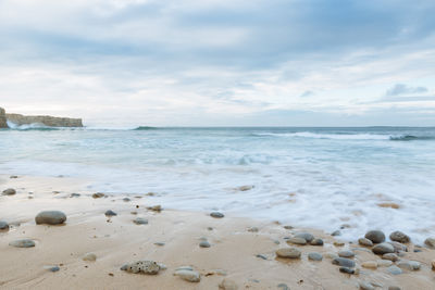 Scenic view of sea against cloudy sky