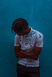 Full length of boy standing against wall